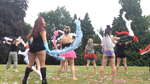 ladies dancing outside  at a private event with feather boas